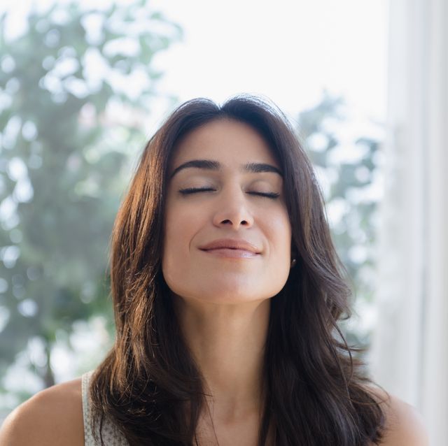 calm woman breathing with eyes closed