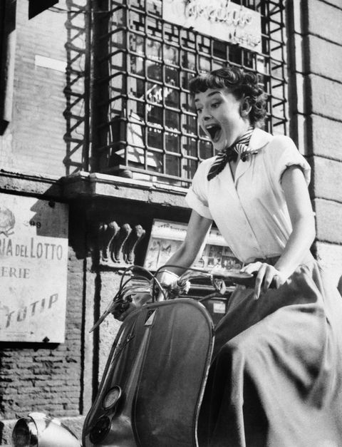 audrey hepburn gleefully drives a motorscooter on the set of roman holiday