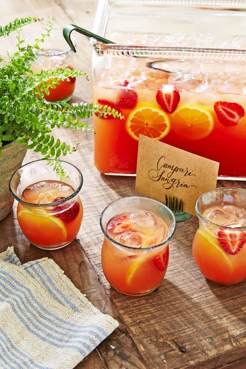 glasses of campari sangria with strawberry and slices of lemon