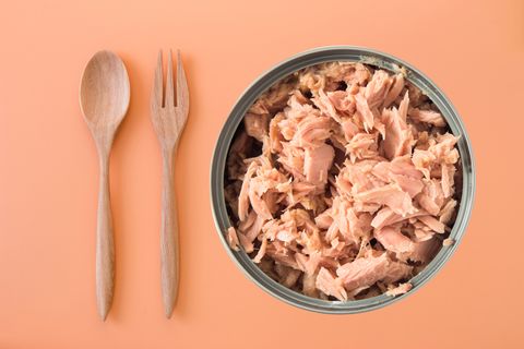 canned tuna isolated on orange background / Canned soy free albacore white meat tuna packed in water