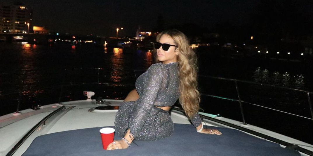 Beyoncé Wears Crop Top, Skirt, and Holds a Red Solo Cup on a Yacht