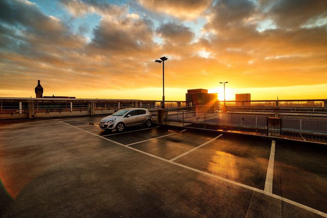 Cars parked in the parking lot in the cloudy sky