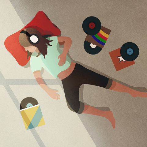 Carefree girl with headphones listening to records