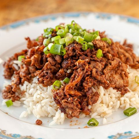 plate of bulgogi over rice, garnished with green onions