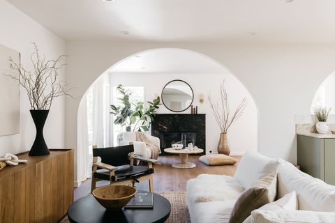 salón abierto con chimenea de mármol negro y muebles de diseño contemporáneo