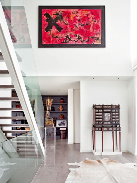 An open space home decorated in industrial style, antique northern furniture and African art