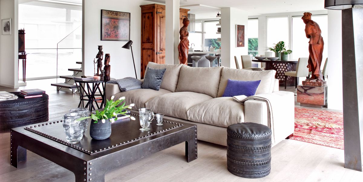 A home with open spaces decorated in an industrial style, antique Nordic furniture and African art