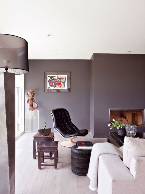 An open space home decorated in industrial style, antique northern furniture and African art