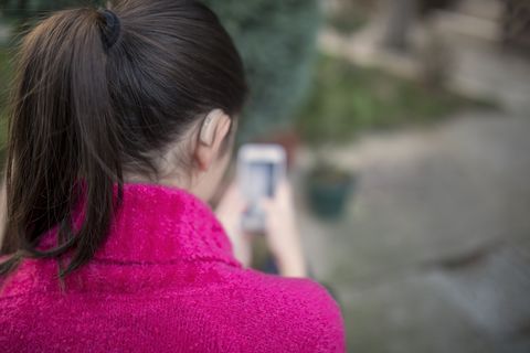 girl with a hearing problem use smartphone