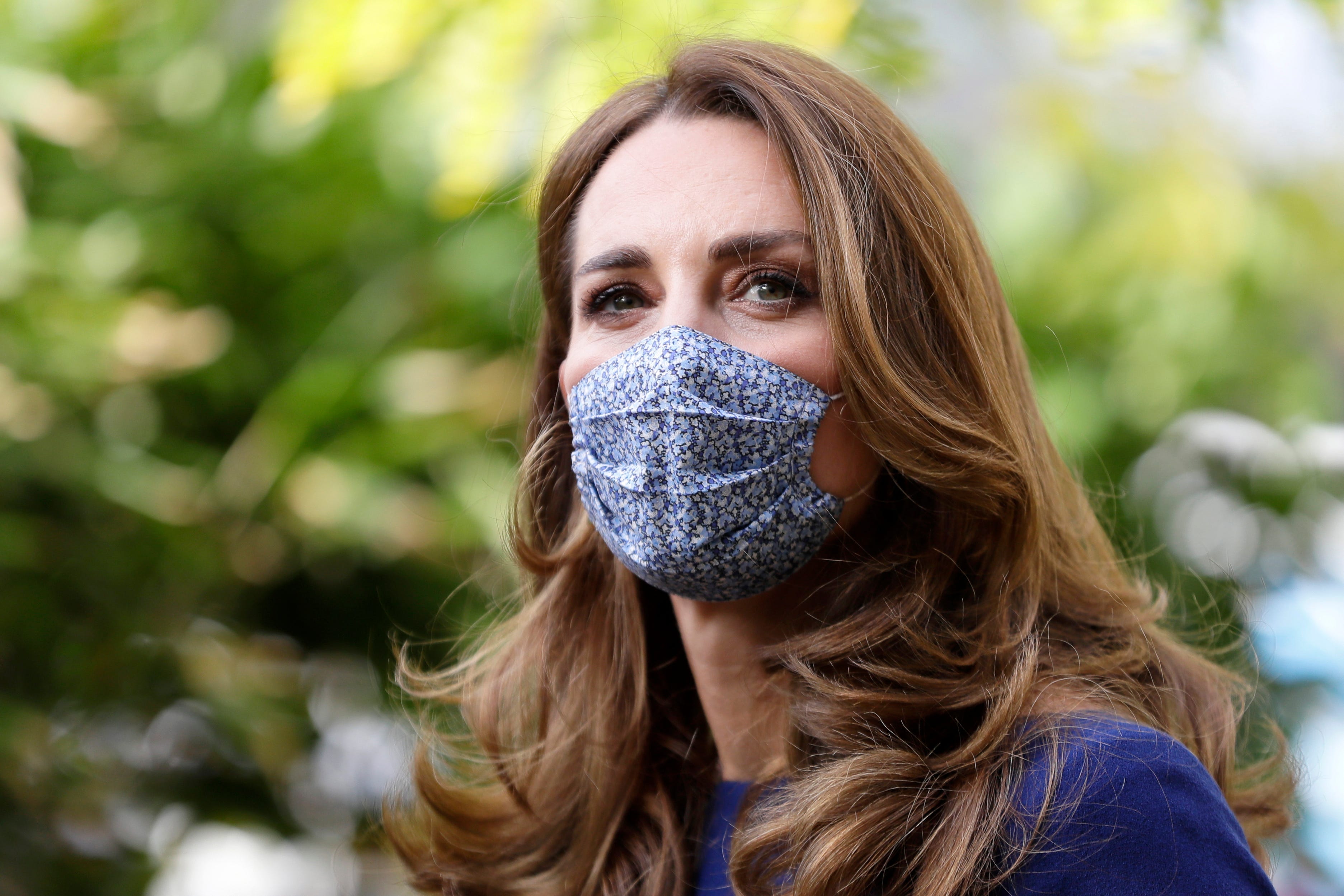 Kate Middleton Steps Out in Chic Sapphire Dress and Floral Mask for Tommy’s Engagement