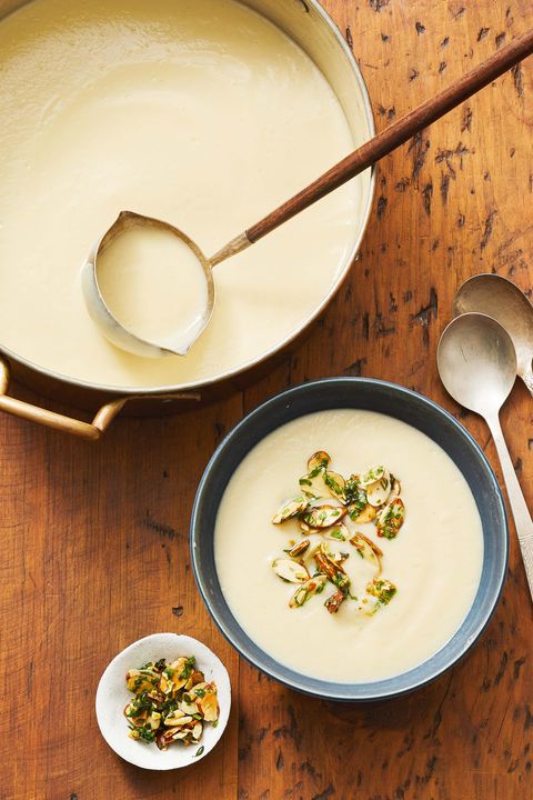 a pot and bowl of cauliflower soup