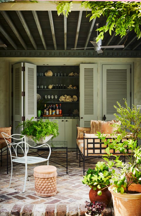 poolside drinks are served from a glazed tile bar behind folding louvered doors