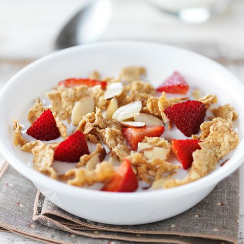 cold cereal with nuts, strawberries, and milk