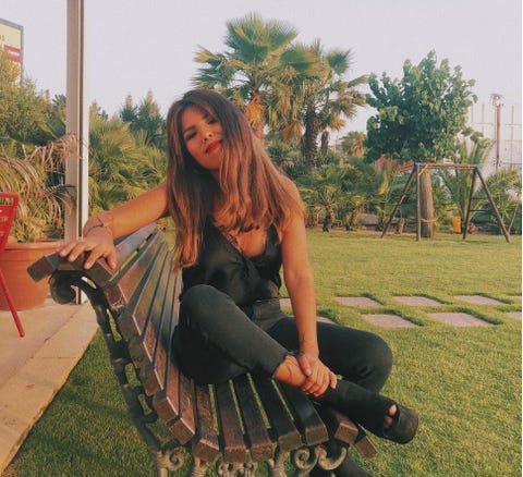 Sitting, Footwear, Leg, Grass, Tree, Long hair, Plant, Leisure, Shoe, 