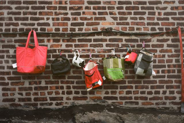 chalk bags hanging on a brick wall