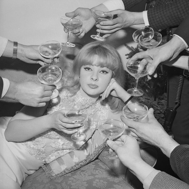 31st december 1963  mandy rice davies, a welsh showgirl and witness in the profumo affair, surrounded by champagne at the press launch of her book the mandy report  photo by harry dempsterexpressgetty images