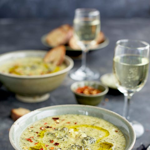 Charred Broccoli Cheddar Potato Soup drizzeled with Olive Oil and sprinkled with red chili flakes with Crostini.