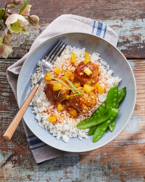 sweet and sour chicken meatballs topped with pineapple over rice