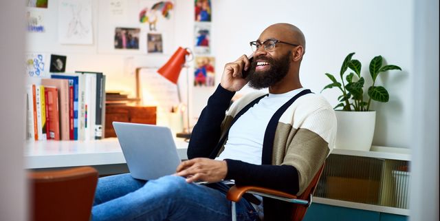 cheerful businessman working from home on phone