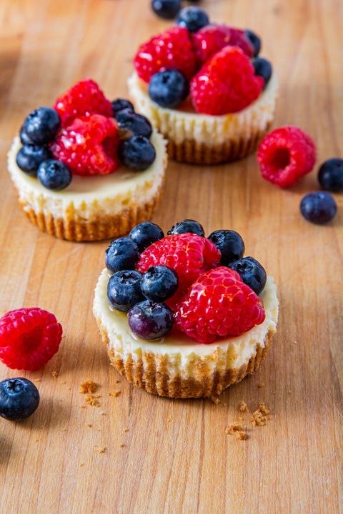 cheesecake cupcakes topped with glazed berries