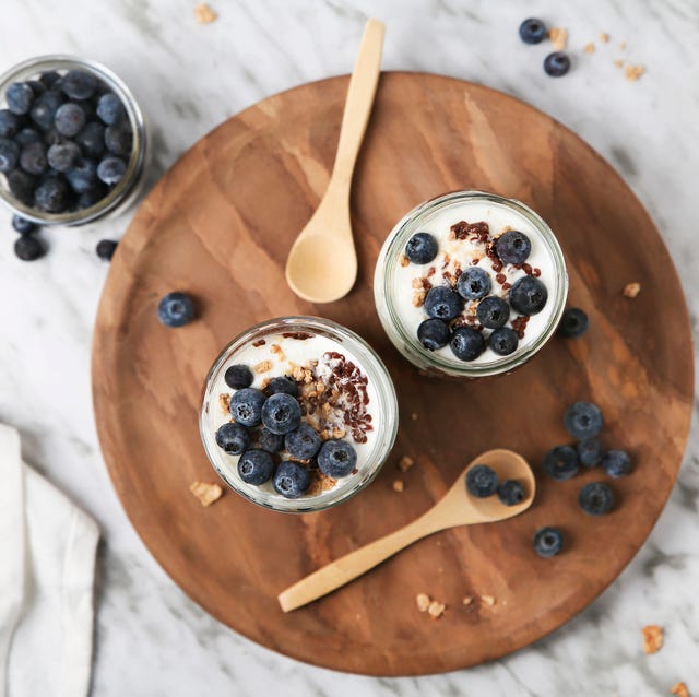 chia pudding parfait with chocolate and yoghurt with blueberries and granola in jars