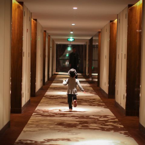 child running in the hotel corridor