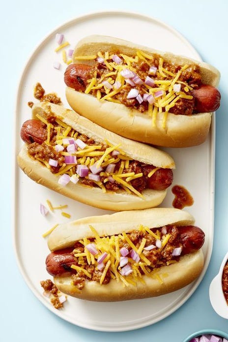 Chili Dogs chili dogs with cheese and red onions as toppings