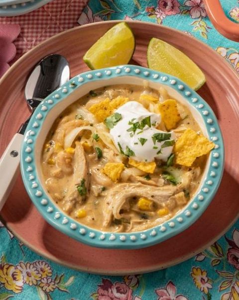 white chicken chili with chips and lime wedges