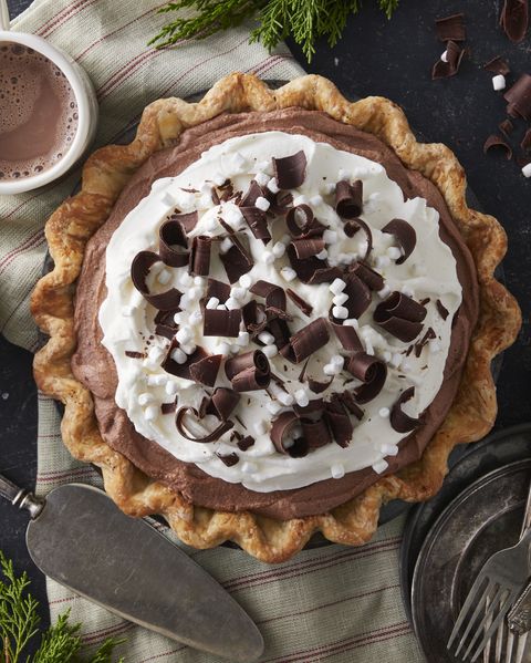 hot chocolate ice box pie topped with whipped cream chocolate curls and mini marshmallows
