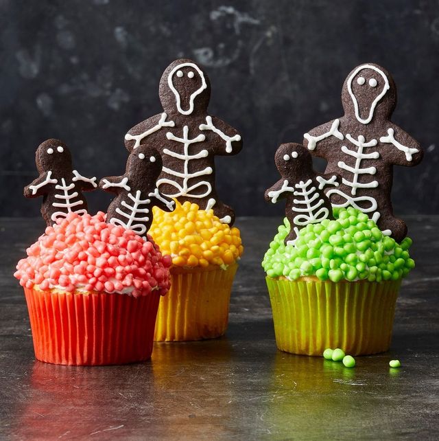 chocolate skeleton cookie cupcakes with red, green and yellow icing