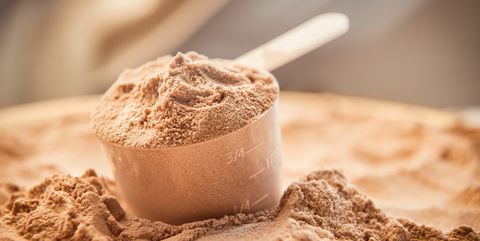 Chocolate whey protein powder with a filled scoop