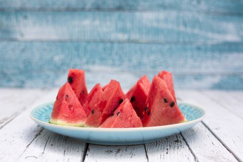 Chopped watermelon on blue plate