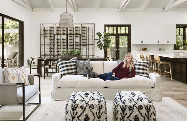 christina anstead sitting on a couch next to her dog