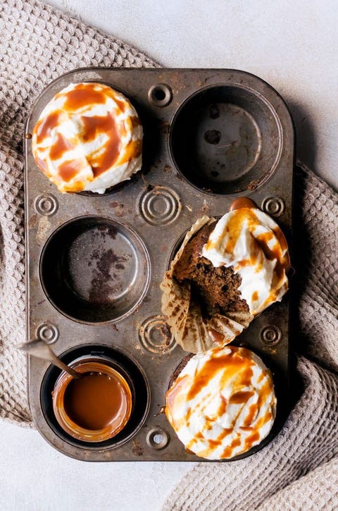 pumpkin spice latte cupcakes in cupcake pan with towel under