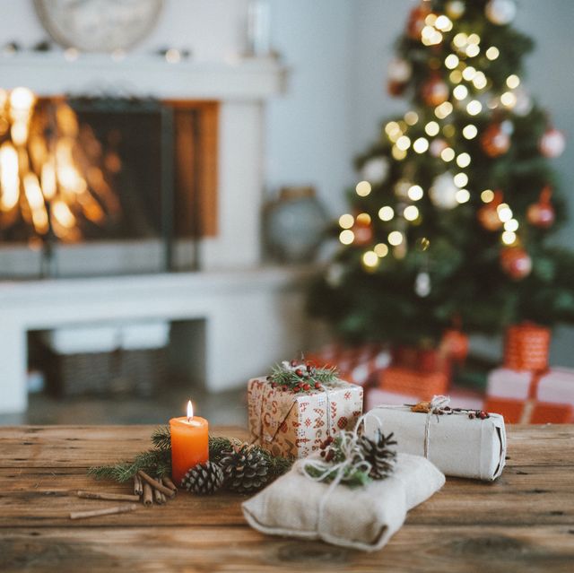 beautifully decorated home for christmas with a christmas tree , candles and christmas gifts
