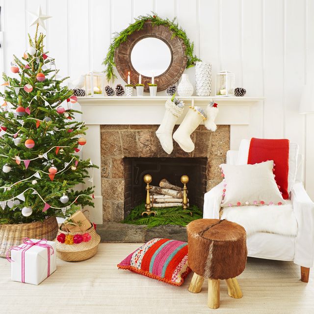 living room with stockings on the mantel, fireplace, christmas tree