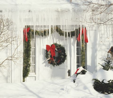 christmas decorations and icicles by front door of house