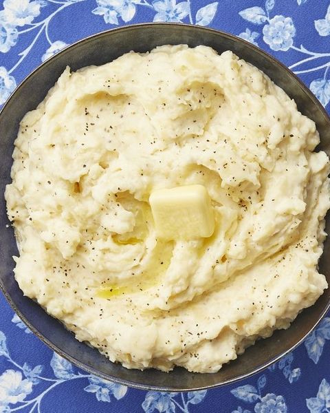 instant pot mashed potatoes with butter on blue surface