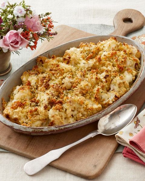 cauliflower gratin in dish on wooden board with spoon
