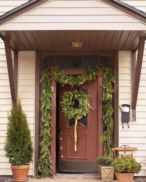 front door decorated with greenery