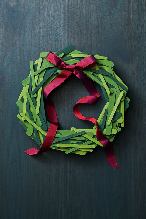 christmas door decorations, wreath made of green popsicle sticks, with a red ribbon