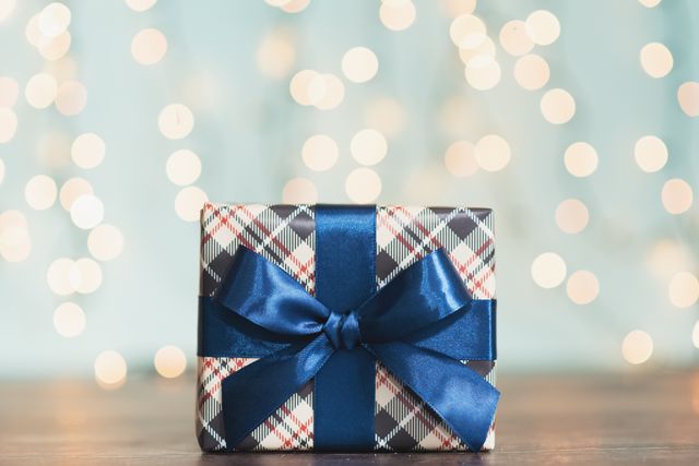 christmas gift box against turquoise bokeh background holiday greeting card