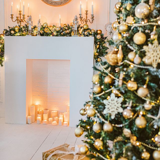 christmas living room decoration, white and gold colors interior decoration background, xmas home decoration with presents, christmas lights and tree indoors