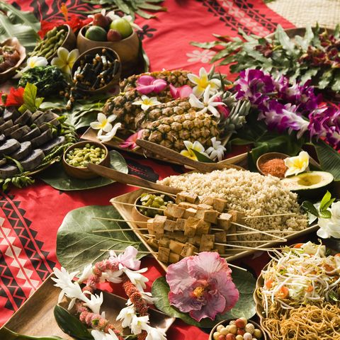 christmas party themes where a blanket is full of luau food for guests