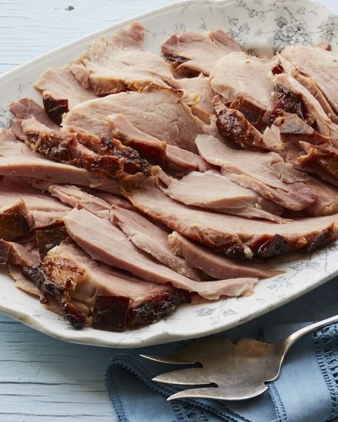 root beer glazed ham on platter with fork