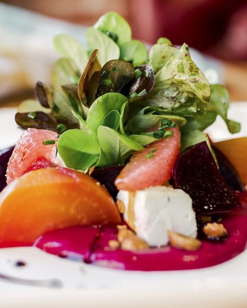 roasted beet salad on white plate with greens