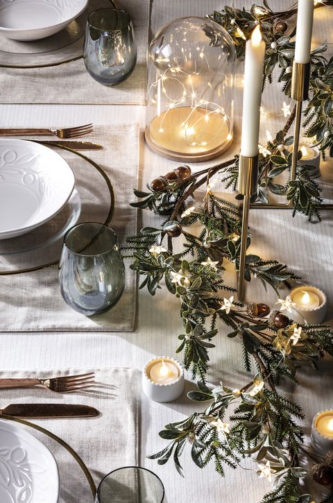 christmas table decoration with led candles and a garland