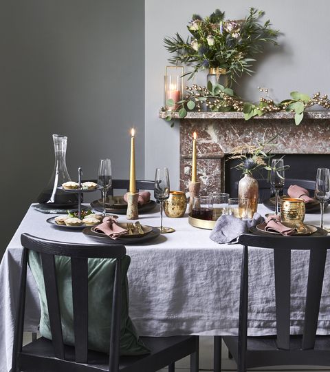 christmas decorated table by a mantle piece pewter plateson mantelpiececandleholder, £39,west elm vase, £75 for two, cox  cox bouquet, £38, bloom wild table, £719chairs, £229 each both willis  gambier tablecloth, £75, piglet cushion, £18, barker  stonehouse trivet,£16 cutlery set, £35 both debenhams decanter, £6750 champagne flutes, £1450 each tray, £9550 vase, £32 candlesticks, £7640 for four all broste copenhagen candles, £450 each, curious eggtealight holders, £10 each, national trust shop dinner plates, £10 each, habitatsalad plates, £10 each, west elm tumblers, £33 for six, neptune cakestand, £28 coasters, £32 for four both rowen wren pink napkins, £549 each, linenme grey napkin, £18 for two, chalk pinklinen company mince pies, £799 for six, daylesfordgiftwrap, £3sheet, rowen wren brass dish, £32 for four, broste copenhagen