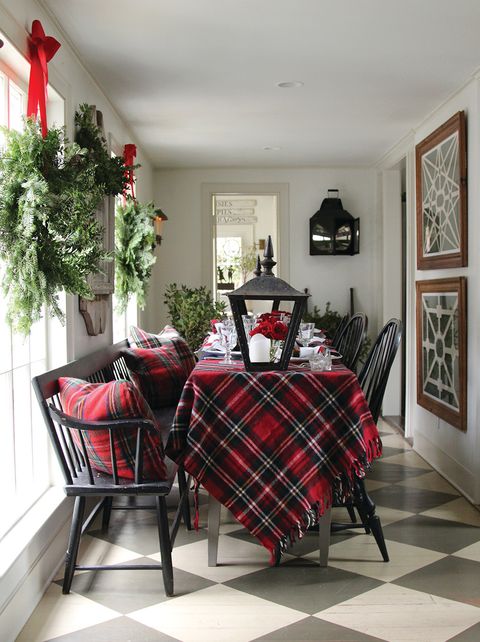 christmas dining room with black chairs and plaid blanket used as a tablecloth