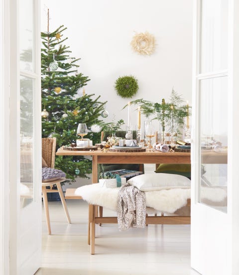 cover shot, wooden dinning table with a christmas tree in the corner of the room